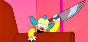 haunted krusty doll from an episode of the simpson with a knife